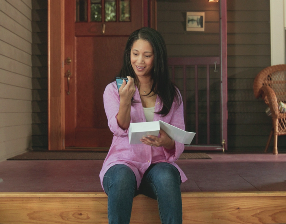 A woman receiving a repaired phone in the mail