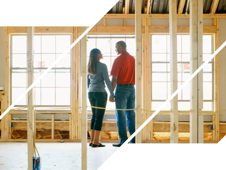 A couple stands in a house under construction and looks at each other.