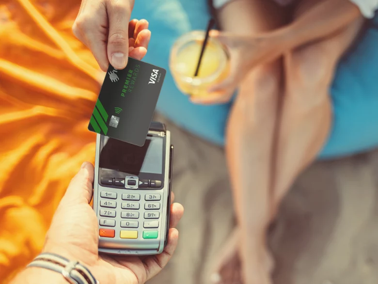 women paying for a drink on the beach