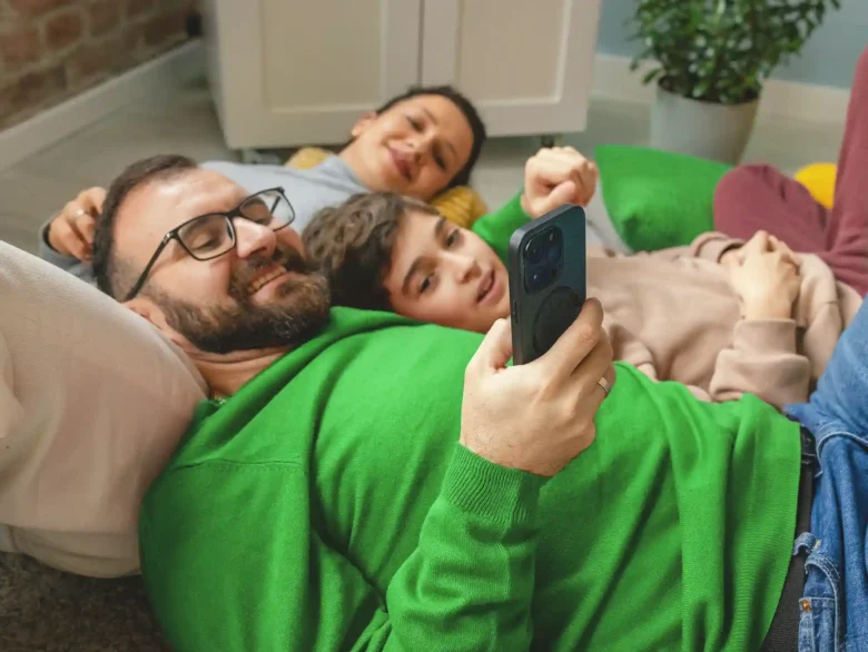 Family of three laying on their home floor