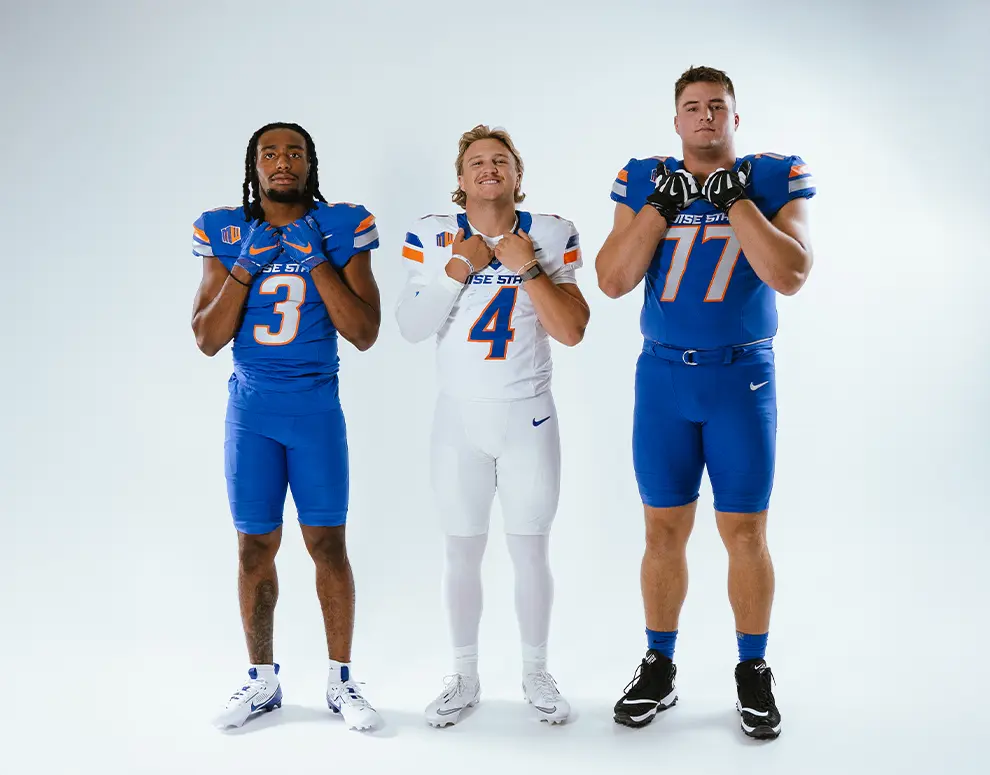 Boise State Football student-athletes Maddux Madsen, Latrell Caples, and Kage Casey posing together.