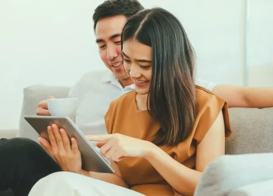 Couple reviewing finances on a tablet at home