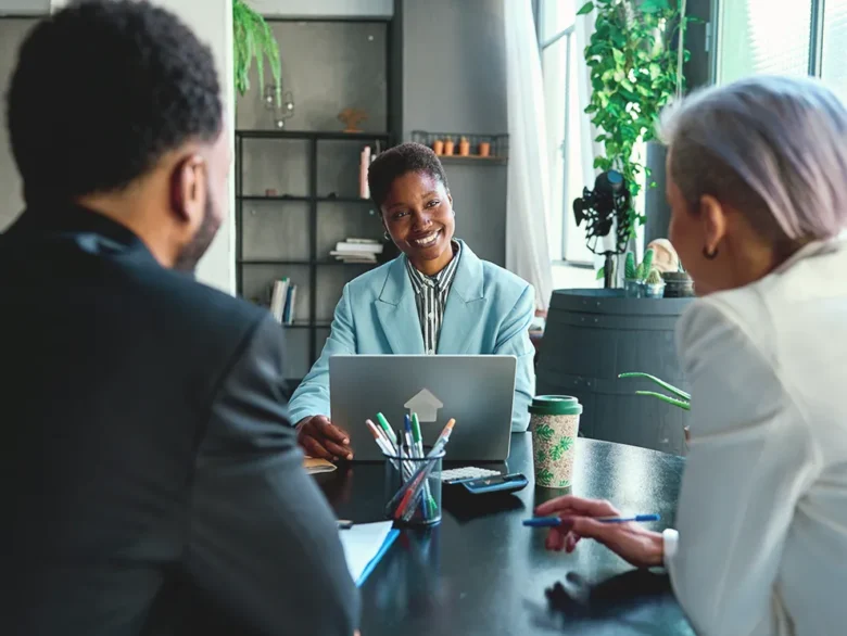 Couple meeting with a financial advisor to discuss financial planning options in a professional office setting