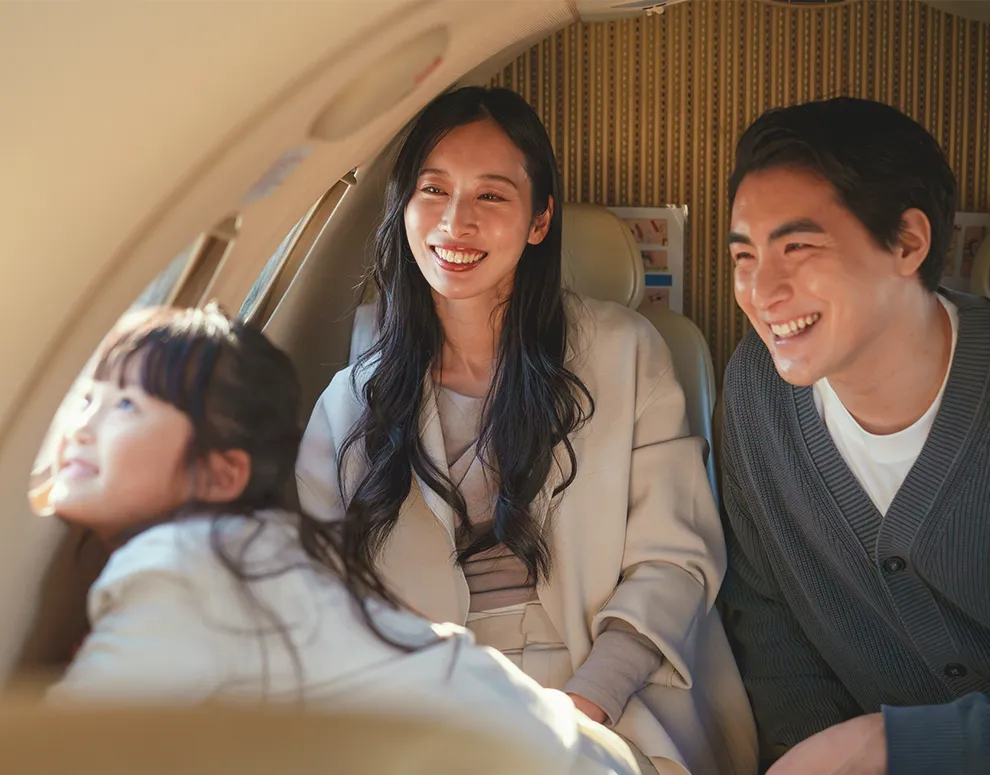 Family enjoying time together inside a private aircraft, symbolizing successful financial planning and future security