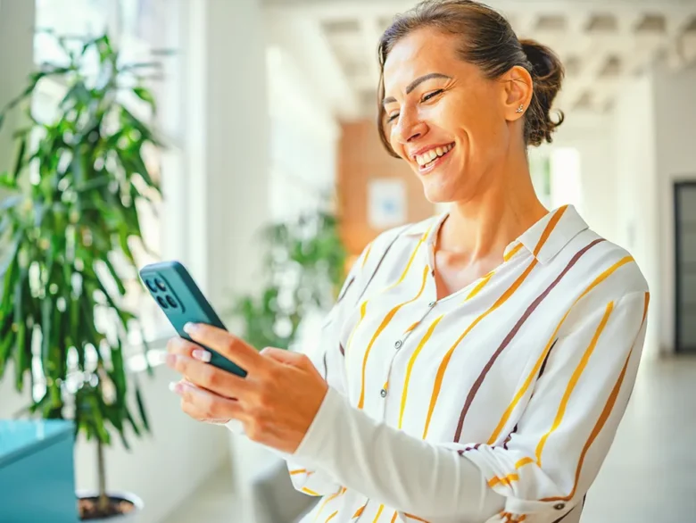Individual using a smartphone indoors, symbolizing getting started with online banking and financial services