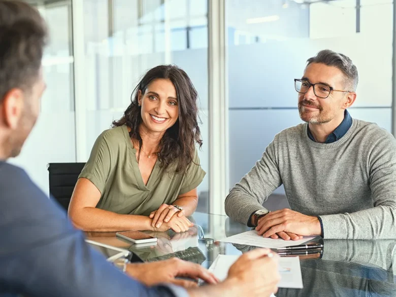 Clients meeting with a financial advisor to review paperwork and discuss financial planning options