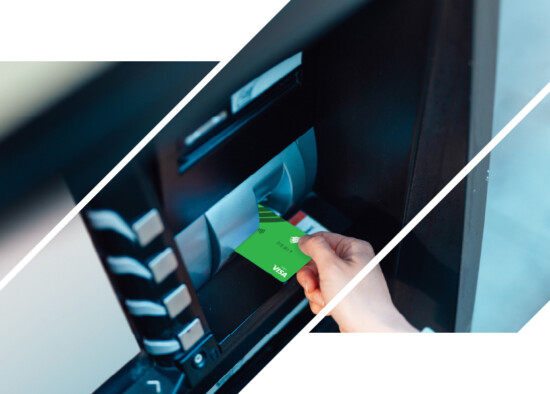 Someone putting an ICCU debit card into an ATM.