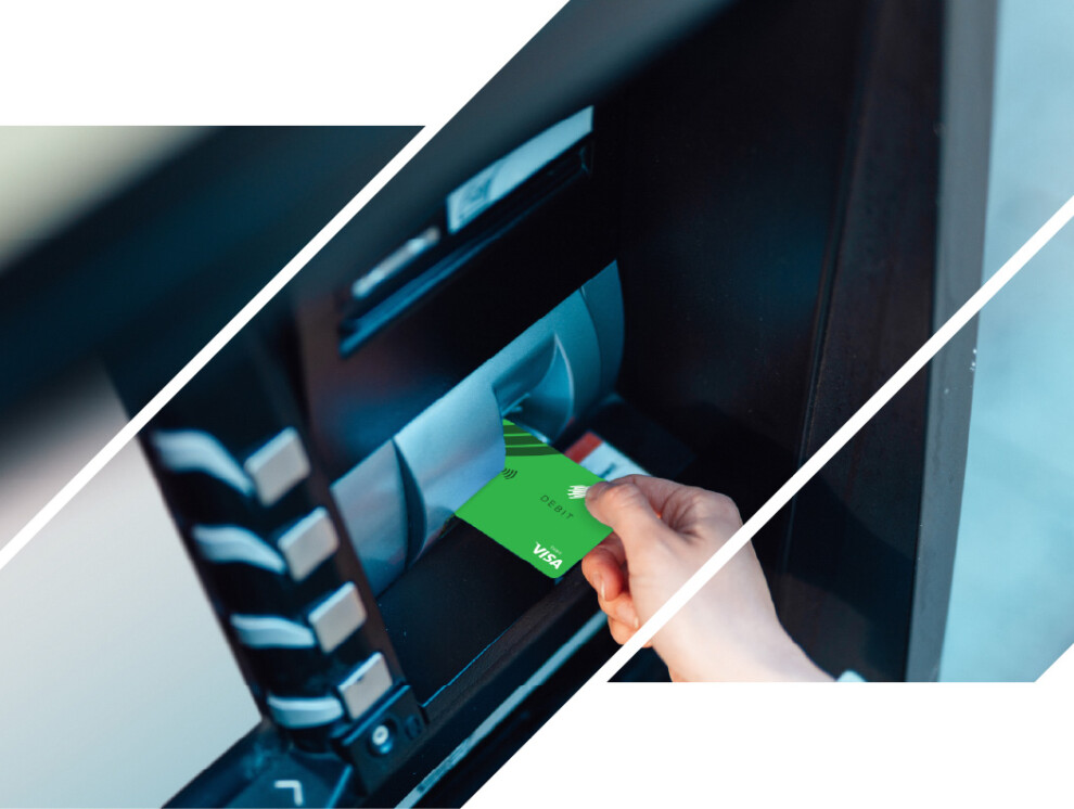 Someone putting an ICCU debit card into an ATM.