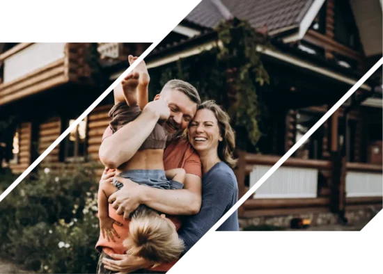 A smiling couple plays with their son in front of their new house.