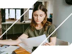 Woman compares mortgage rates and fees at a table with papers.