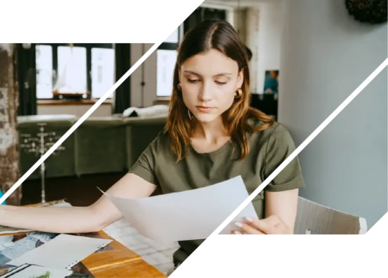Woman compares mortgage rates and fees at a table with papers.