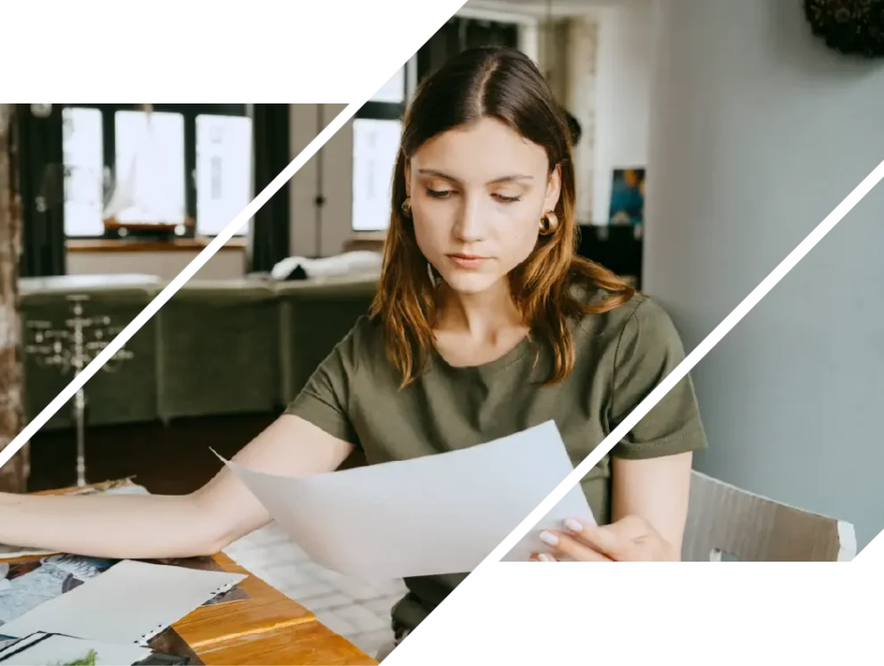 Woman compares mortgage rates and fees at a table with papers.