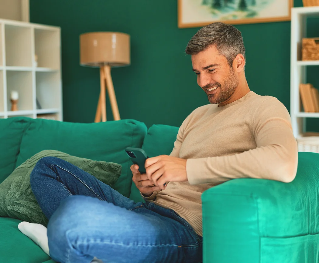 Person checking account and tracking spending on a mobile phone, using eBranch financial wellness tools