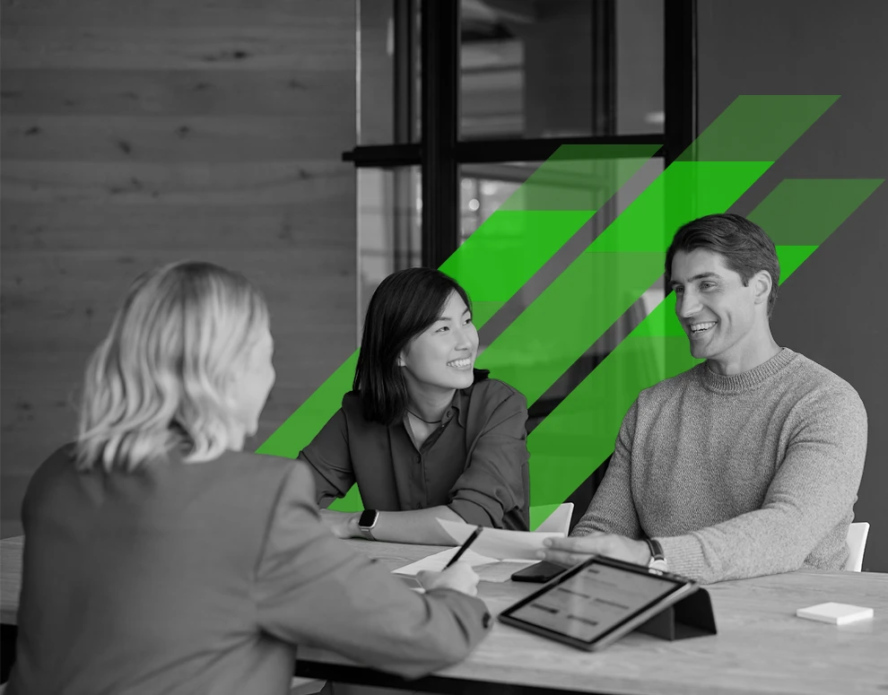 A couple meeting with a financial officer, and green stripes in the background