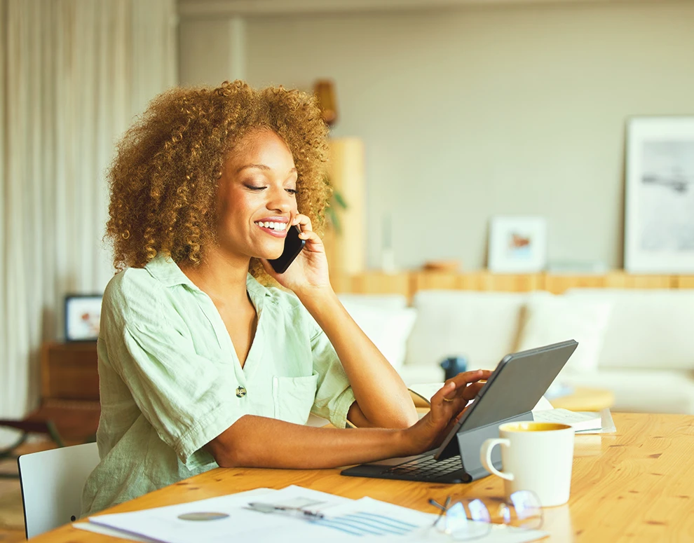 Person using a laptop at home to manage savings and achieve financial goals online.