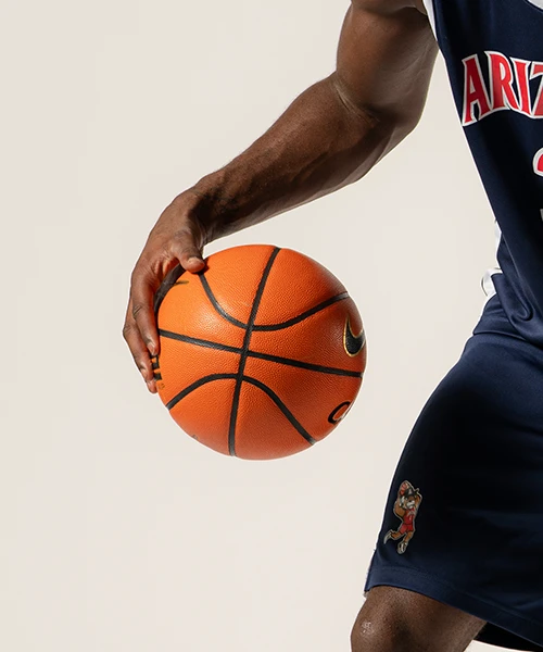 University of Arizona men's basketball player dribbling a basketball.