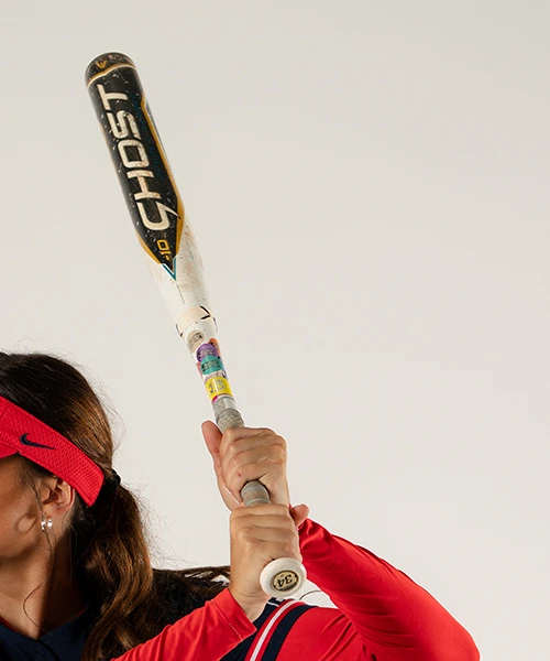 University of Arizona softball player preparing to swing a bat.