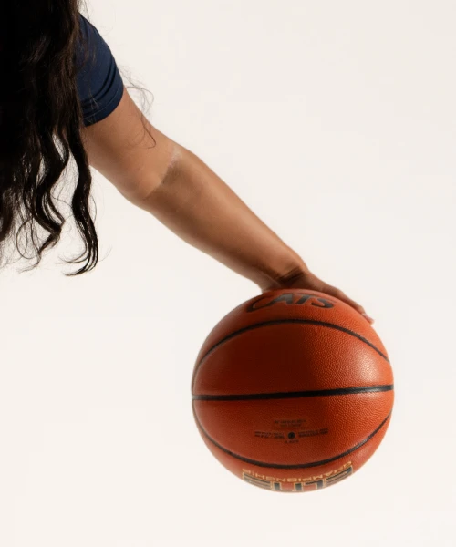 University of Arizona women's basketball player holding a basketball.